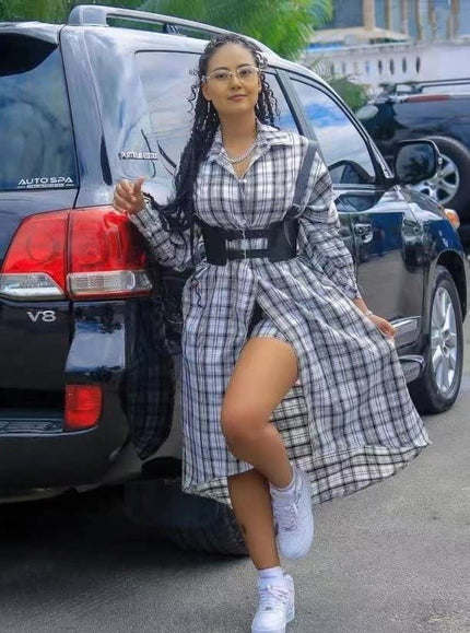 Checkered shirt dress with button front, long sleeves, and adjustable belt, midi length.
