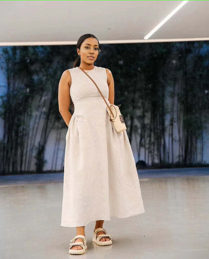 Beige sleeveless maxi dress with pleated waist and full A-line skirt