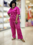 Deep-pink V-neck button-front loose-fit jumpsuit with short sleeves and visible buttons