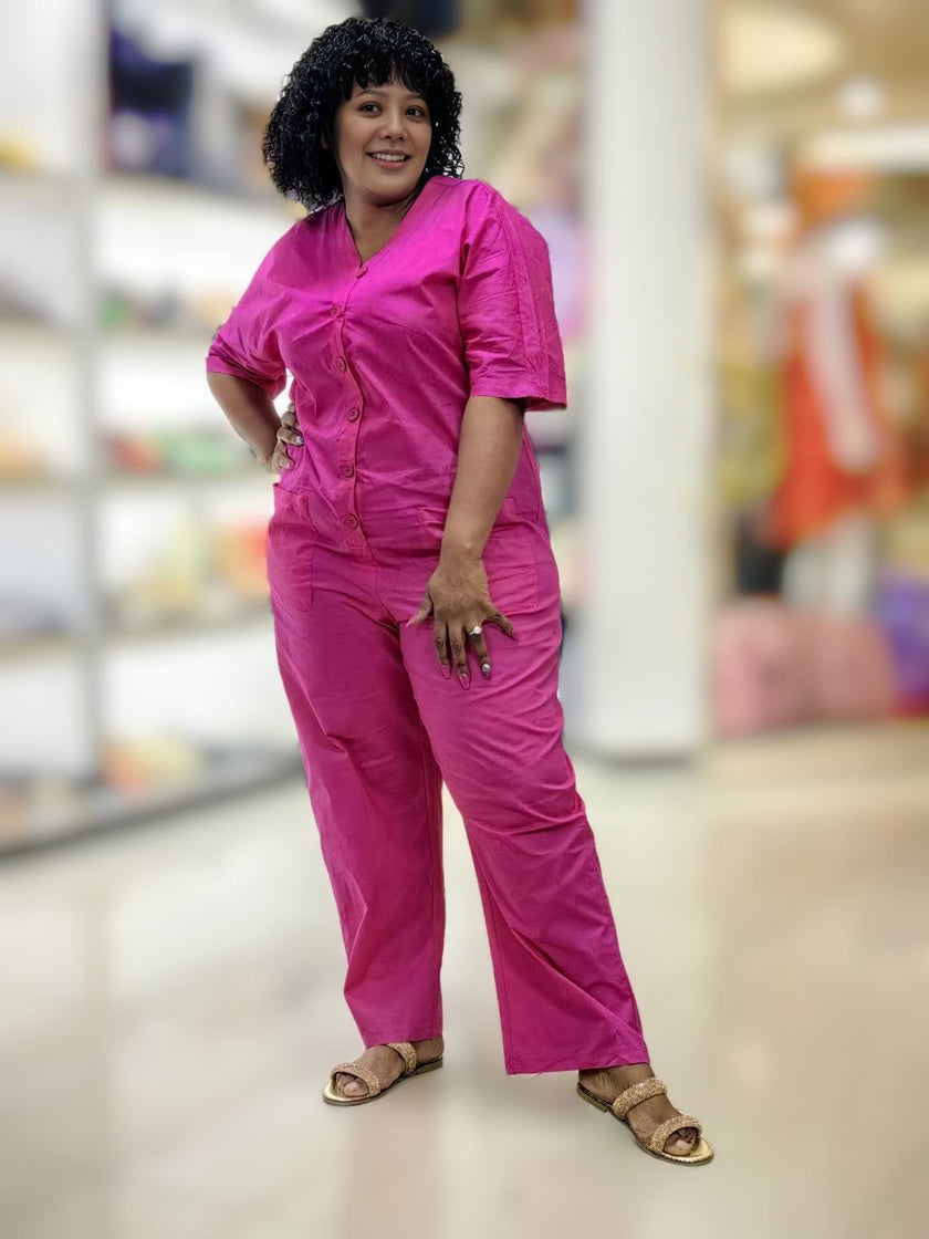 Deep-pink V-neck button-front loose-fit jumpsuit with short sleeves and visible buttons