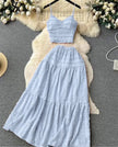 Light-blue pleated maxi skirt with elastic waistband and tiered ruffle texture