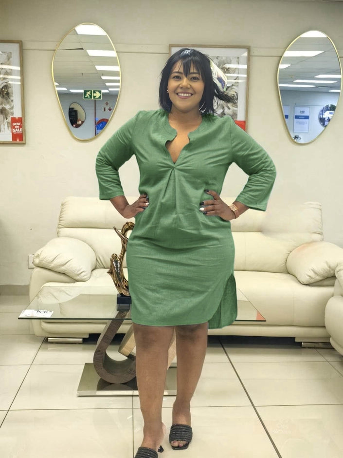 Green shirt dress with V-neck front and three-quarter sleeves, knee length.