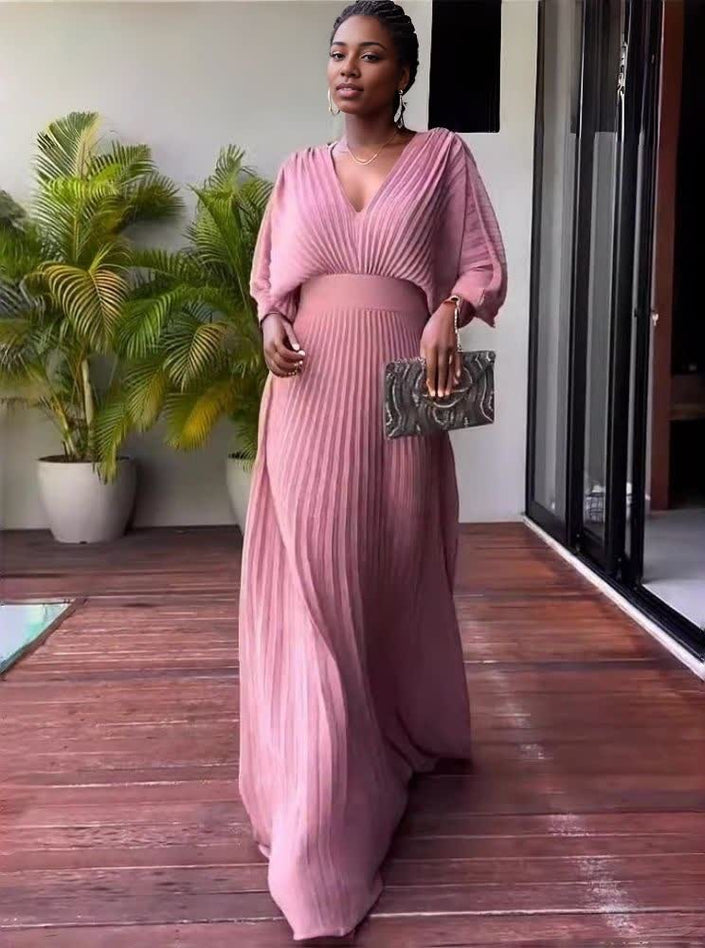 Pink pleated maxi dress with V-neck and batwing sleeves, full-length flowing skirt