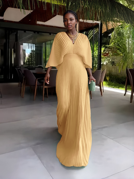 Beige pleated maxi dress with V-neck and batwing sleeves, gathered waist and long skirt