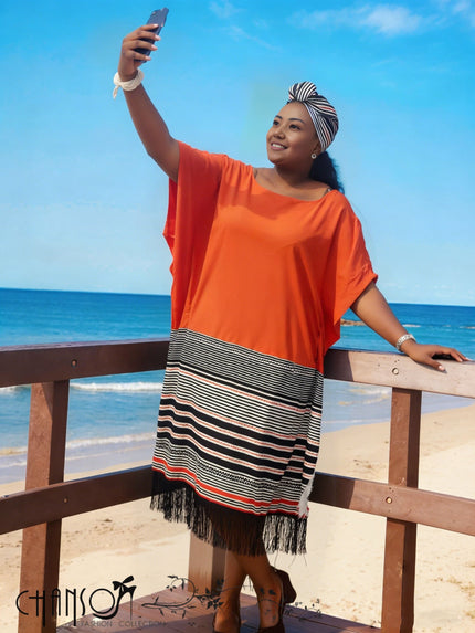 Orange-red midi dress with wide sleeves, striped skirt panels and fringed hem