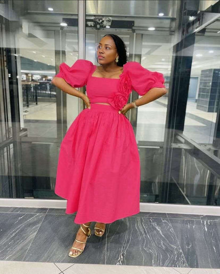 Deep-pink midi dress with puff sleeves, square neckline, floral applique at waist.