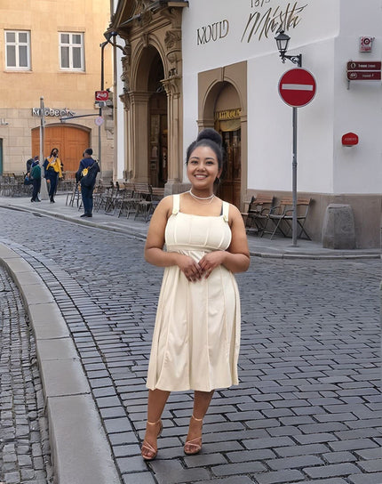 Cream pleated midi dress with sleeveless bodice, square neckline and gathered skirt