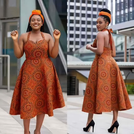 Orange African print midi dress with halter neckline, backless flared A-line silhouette