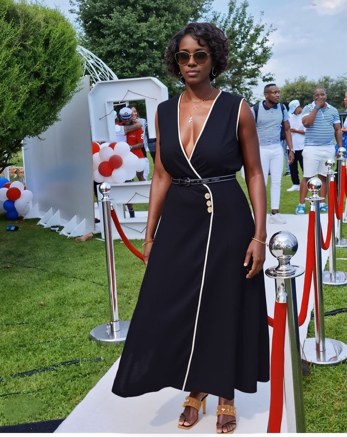 Black sleeveless V-neck midi dress with button accent and white piping