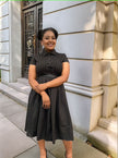 Black belted midi dress with collared button front and pleated midi skirt