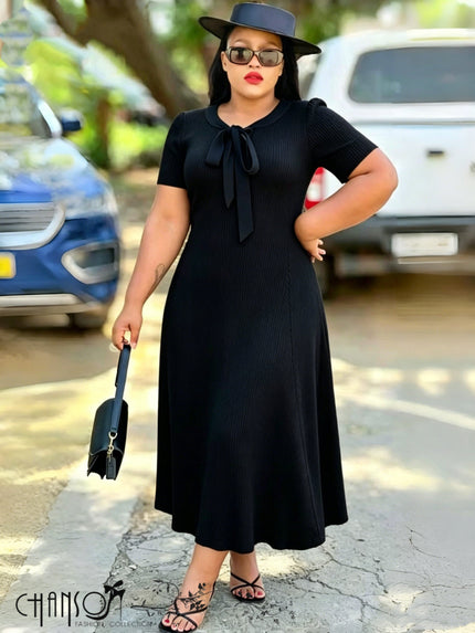 Ribbed A-line midi dress with black bow-tie neckline and short sleeves, black knit