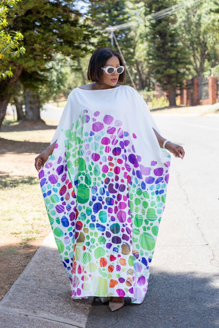 Geometric maxi dress with loose fit, white base, colorful abstract pattern, wide sleeves
