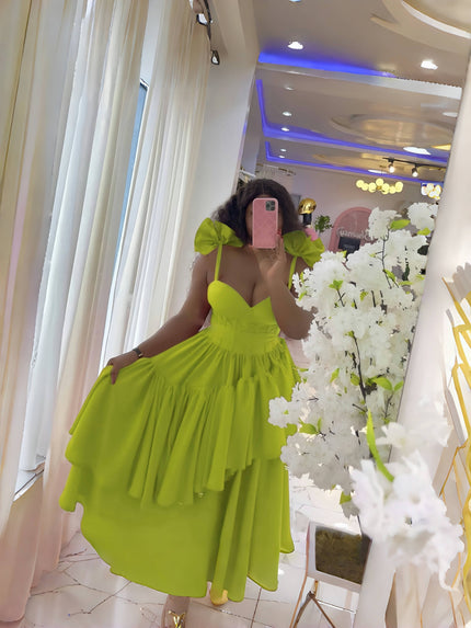 Yellow-green evening dress with layered ruffles, puffy shoulders, and bow spaghetti straps.