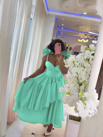Aquamarine evening dress with layered ruffles, puffy shoulders, and bow spaghetti straps.