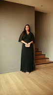 Black pleated maxi dress with V-neck and batwing sleeves, flowing ankle-length skirt