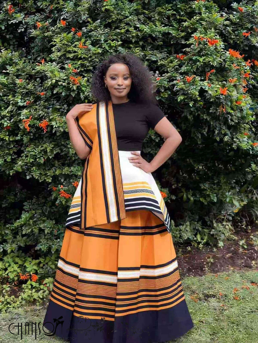 African maxi skirt set with black fitted top and orange striped flared maxi skirt