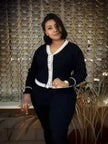 Dark navy knit V-neck cardigan with white trim and button front, long sleeves