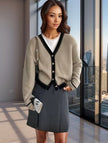 Beige knit V-neck cardigan with black trim and button front, long sleeves