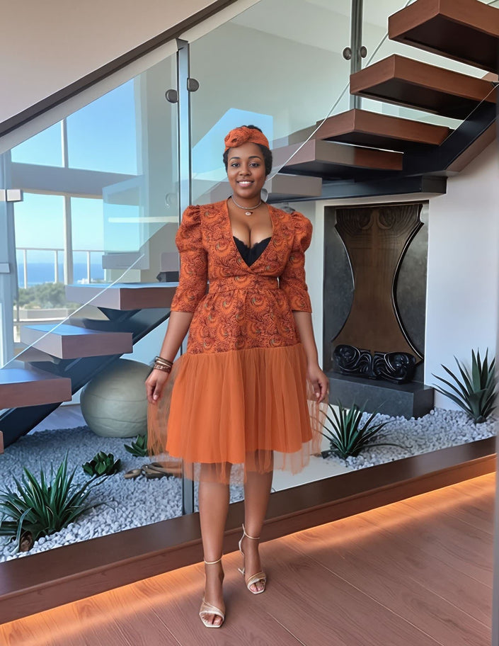 Orange embroidered midi dress with V-neck, puff sleeves, and layered tulle skirt