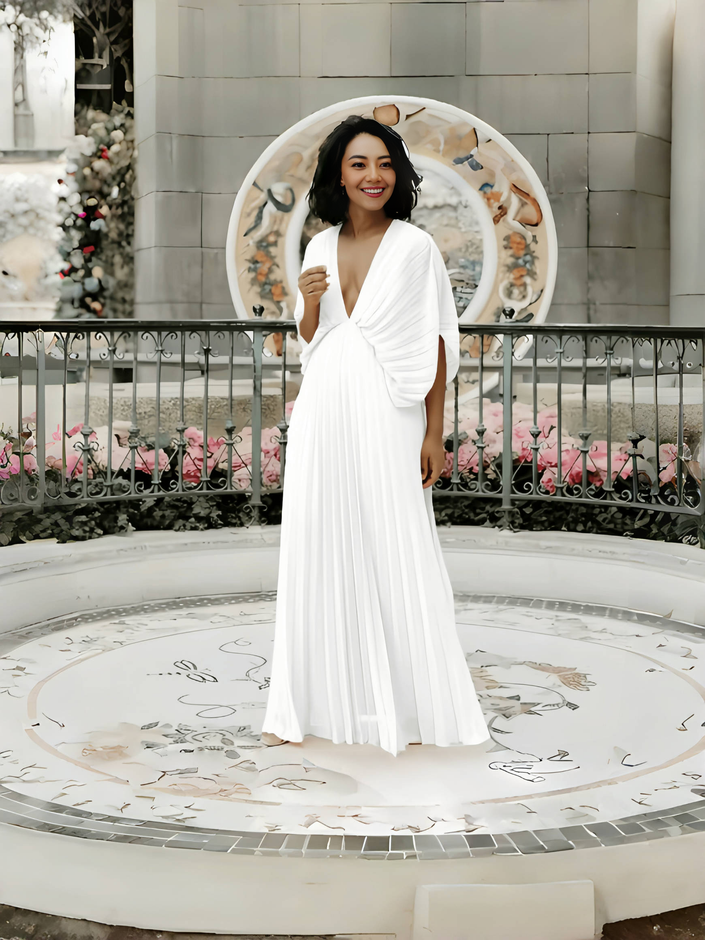 White pleated maxi dress with V-neck and batwing sleeves, full-length drape skirt