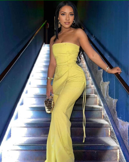 Yellow strapless jumpsuit with cinched ruched waist, side ties, and wide legs