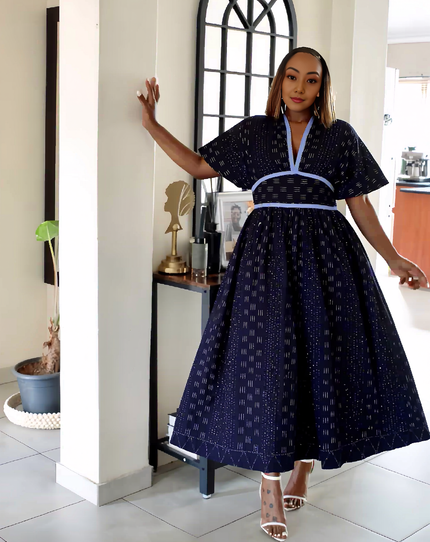 Navy A-line midi dress with puff sleeves, flared skirt and white V-neck trim
