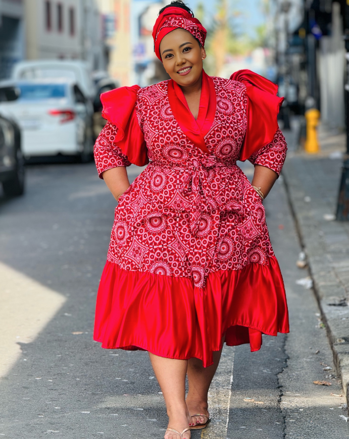 Red midi A-line dress with puff sleeves, ruffled V-neck, and tiered skirt hem.