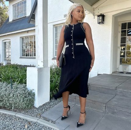 Black knitted midi dress with row of decorative buttons and contrast trim on pockets