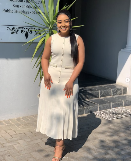 White sleeveless knitted midi dress with decorative button placket and patch pockets