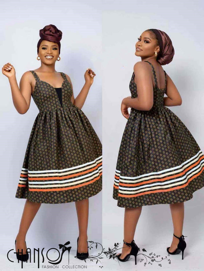 Sleeveless African print flare dress with square neckline, dark patterned bodice and striped hem.