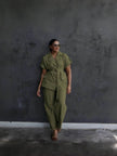 Dark olive belted lapel pantsuit with button-front short-sleeve jacket and loose trousers