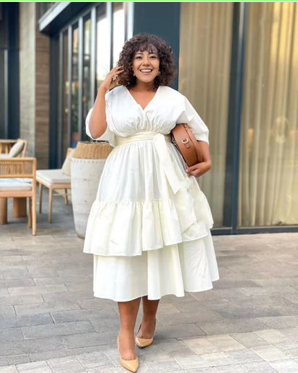 White tiered midi dress with puff sleeves and V-neck, cinched gathered waist