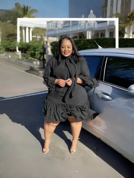 Black pleated midi dress with puff sleeves and ruffle hem