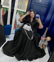 Black puff-sleeve ruffle maxi dress, relaxed fit; V-neck and fluted hem