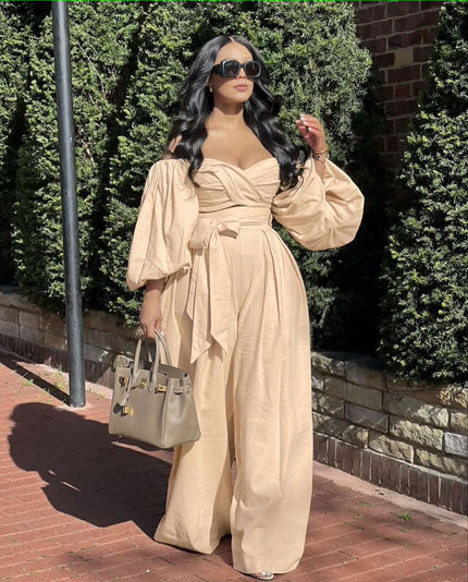 Tan off-shoulder jumpsuit with puff sleeves, ruched bodice, and wide-leg pants