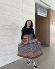 Printed high-waist skirt with black-and-white medallion pattern, orange accents and pockets