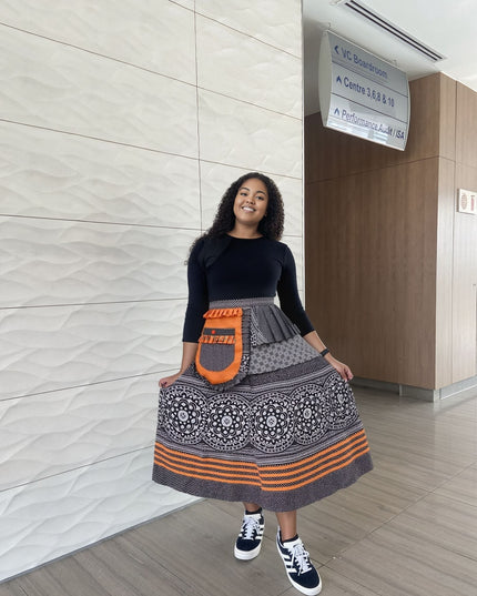 Printed high-waist skirt with black-and-white medallion pattern, orange accents and pockets