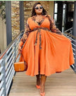 Orange plus size maxi dress with patterned sleeves and waist tie detail