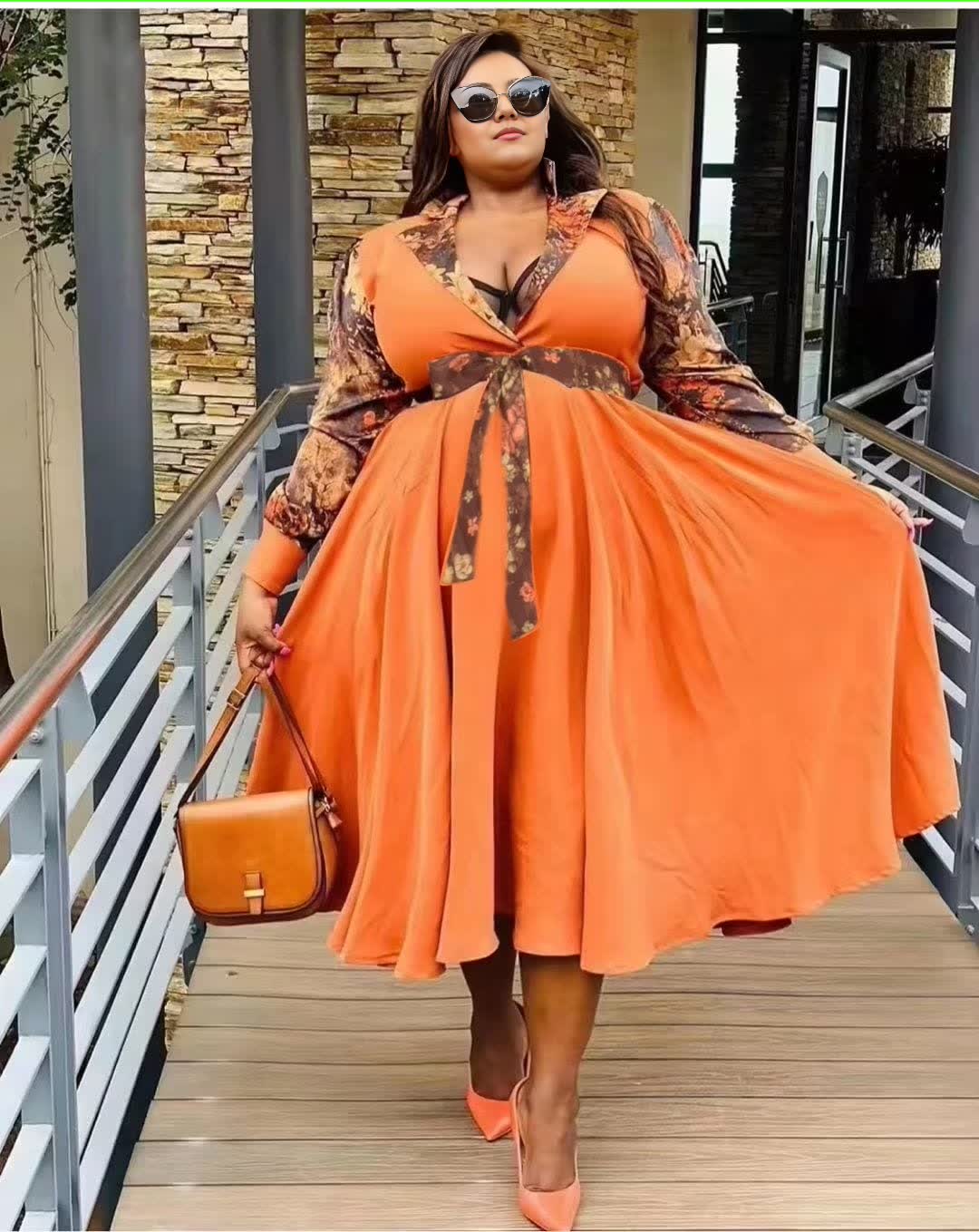 Orange plus size maxi dress with patterned sleeves and waist tie detail