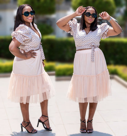 Light pink tiered pleated midi skirt with elastic waist and sheer tulle layers