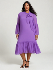 Purple pleated midi dress with neck tie, puff sleeves, and ruffle hem