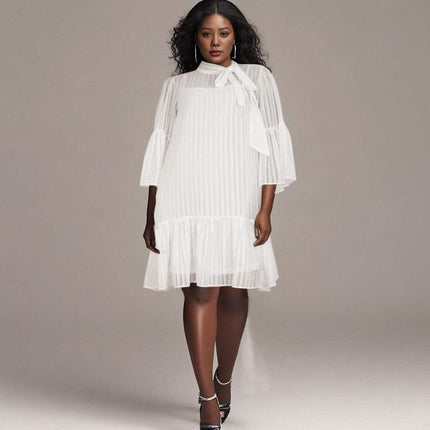 White pleated midi dress with puff sleeves and ruffle hem