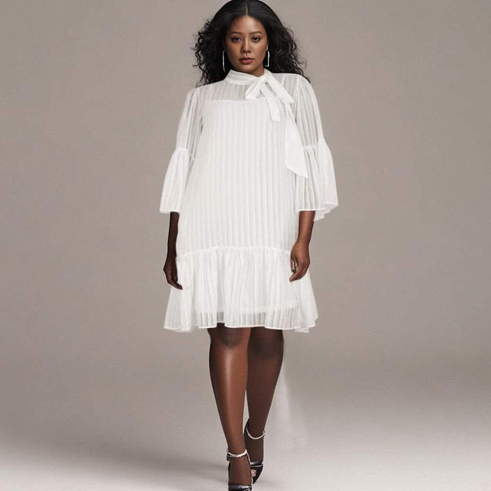 White pleated midi dress with puff sleeves and ruffle hem