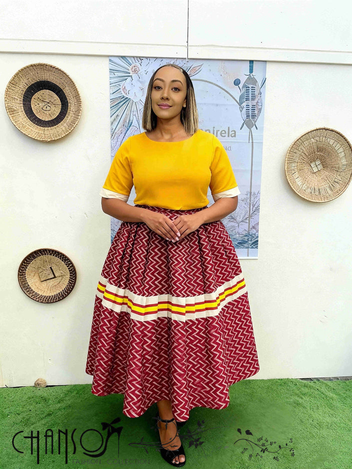 Zigzag midi skirt with red chevron pattern and tiered hem with striped trim