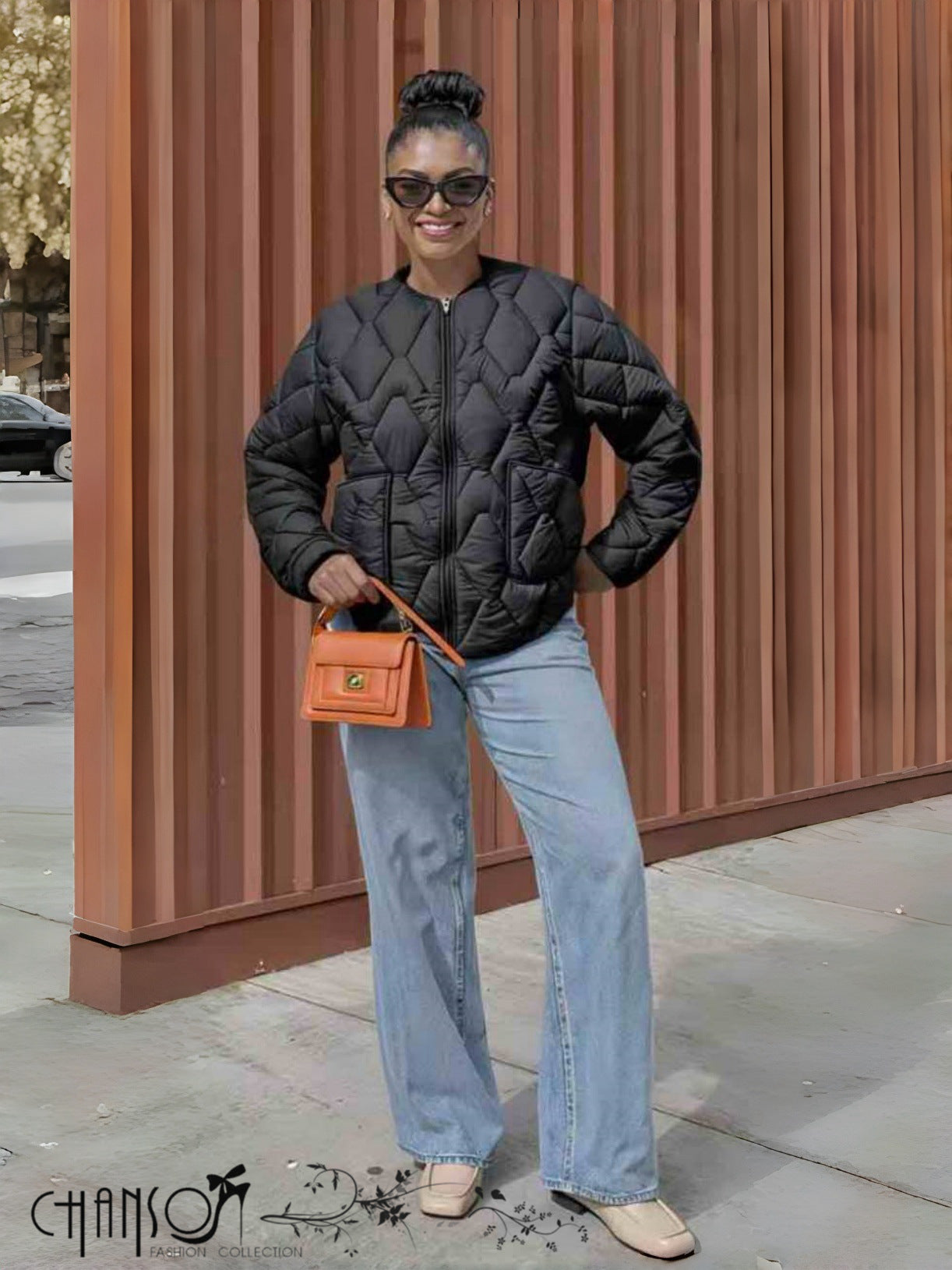 Black quilted collarless jacket with full zip front and diamond pattern stitching