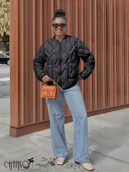 Black quilted collarless jacket with full zip front and diamond pattern stitching