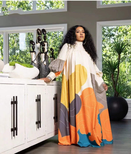 Geometric maxi dress with puff sleeves, cream with yellow, orange, and blue abstract print
