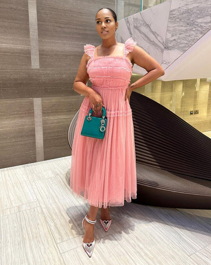 Pink sleeveless tiered ruffle midi dress with smocked bodice and layered tulle skirt
