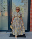 Geometric puff-sleeve maxi dress with cinched waist, button-up bodice, light blue tones