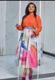 Orange long-sleeve button shirt with colorful watercolor midi skirt